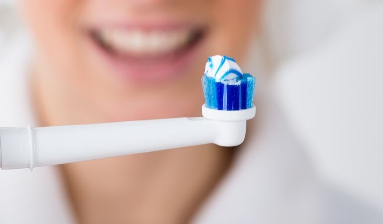toothpaste on electric toothbrush