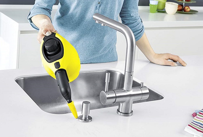 cleaning sink by hand with steam cleaner