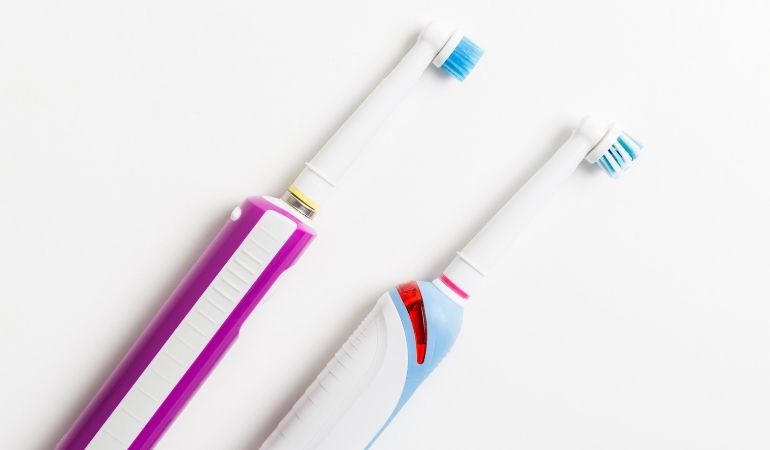 two oral-b electric toothbrushes